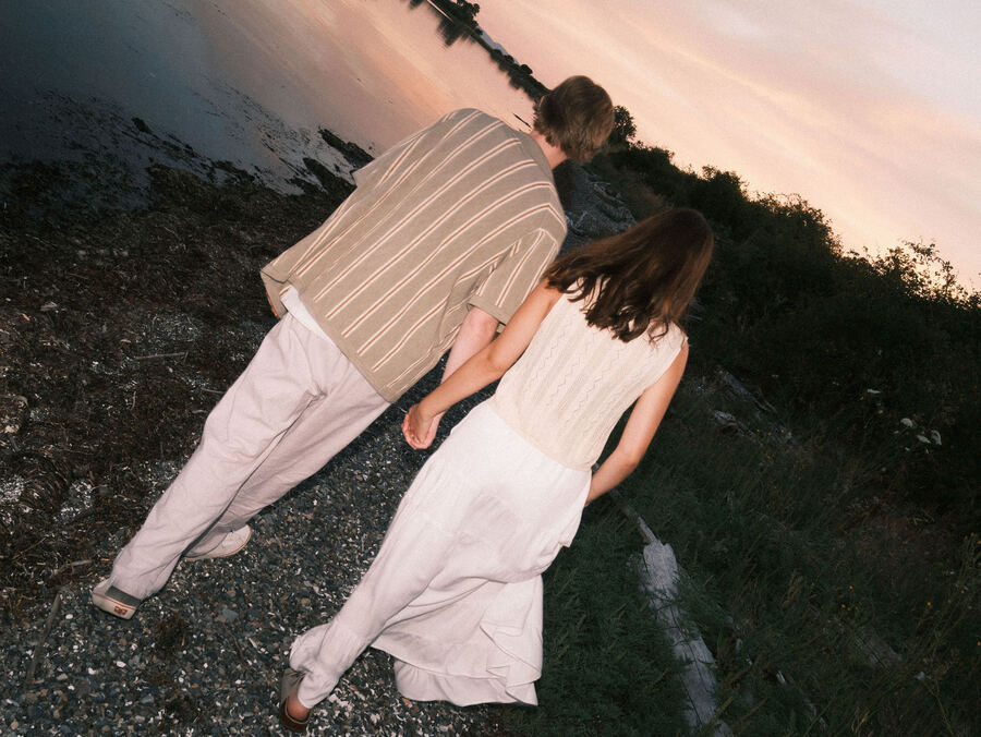 Couple standing side by side at the shoreline