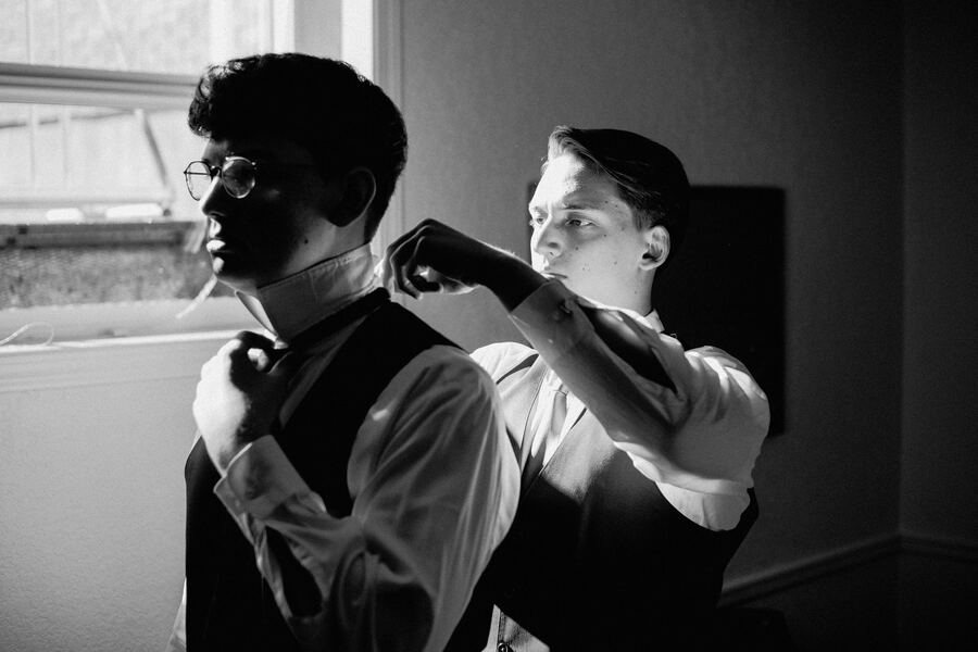 Black and white groomsmen getting ready
