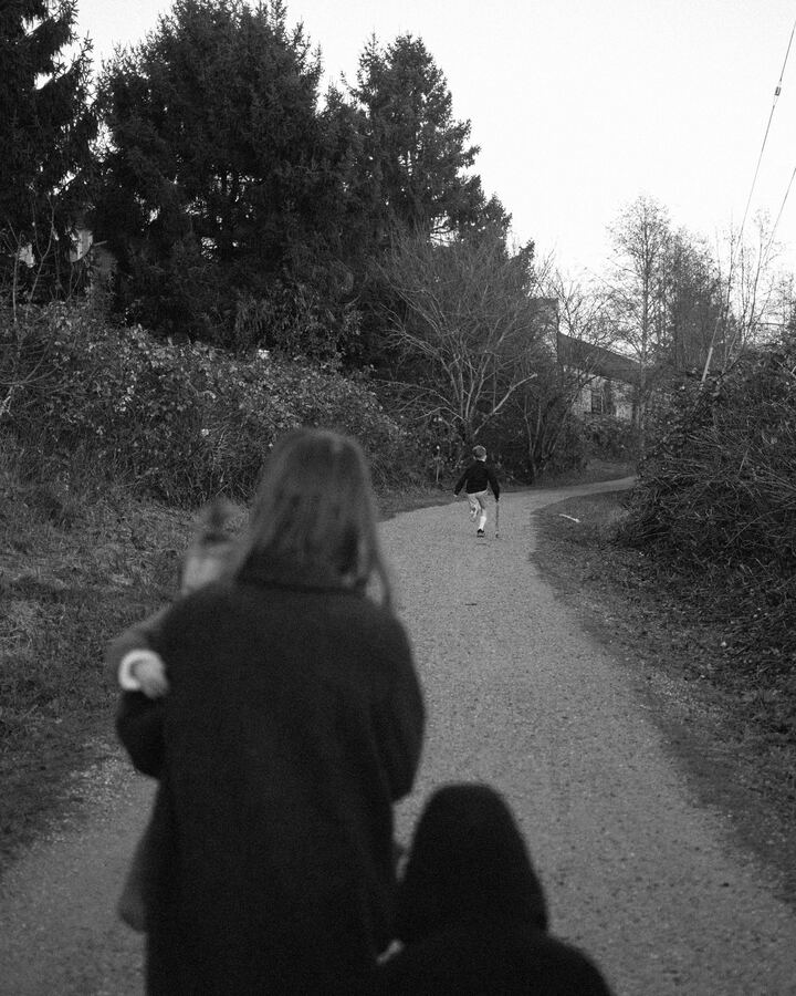 Couple walking down a wooded path