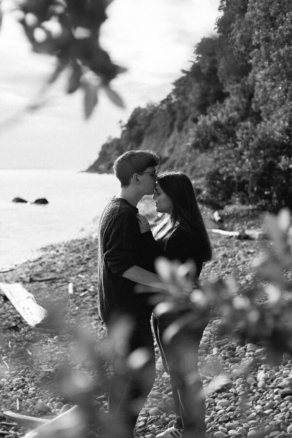 Black and white couple kissing at the beach