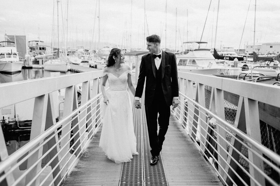 Black and white couple walking down a marina dock