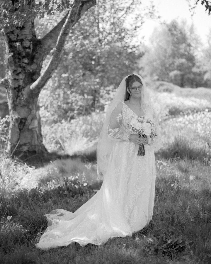 Black and white bridal portrait beneath a birch tree